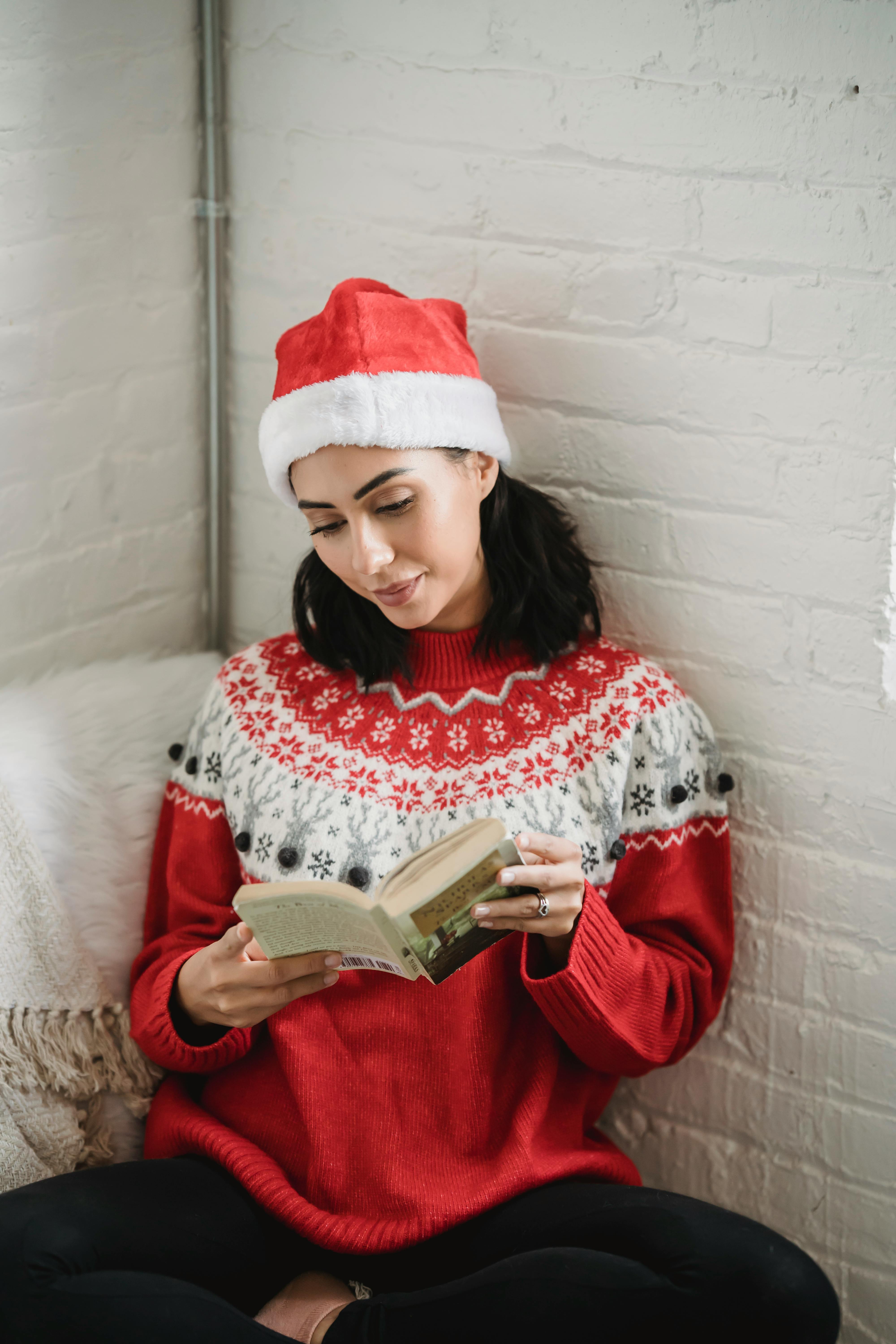 young woman reading book in cozy room