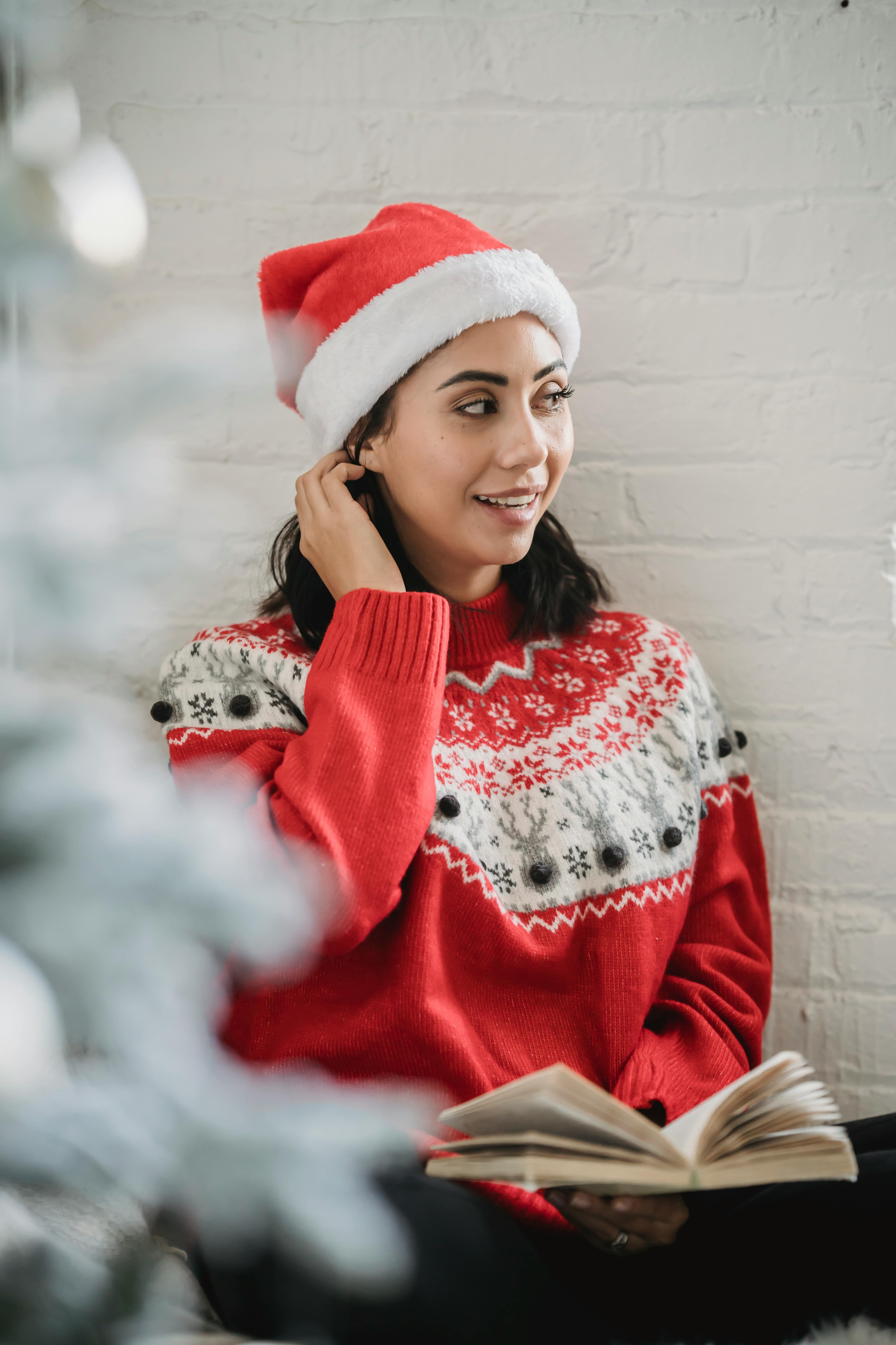 young woman in sweater with book