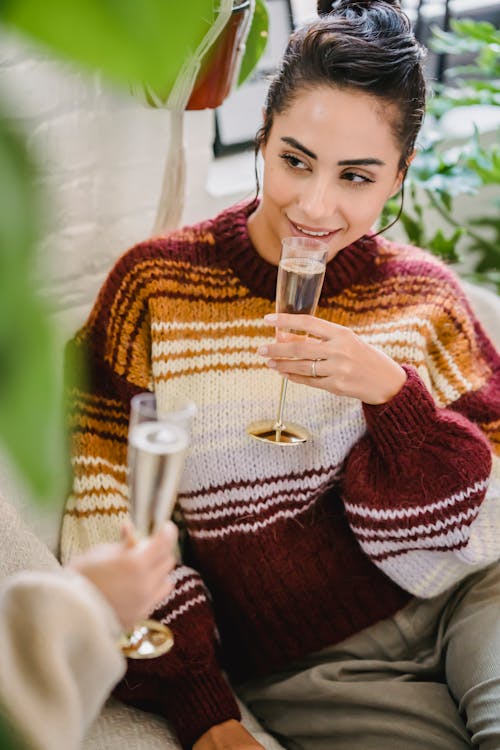 Young woman enjoying wine celebrating holiday with friends