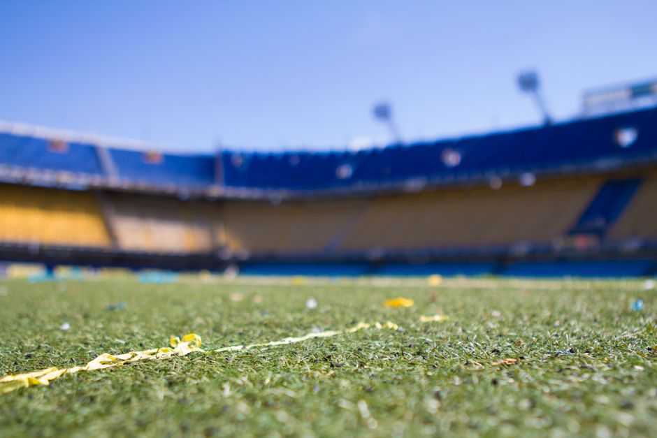 Empty stadium field under blue sky