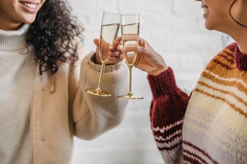 Female friends celebrating holiday with champagne
