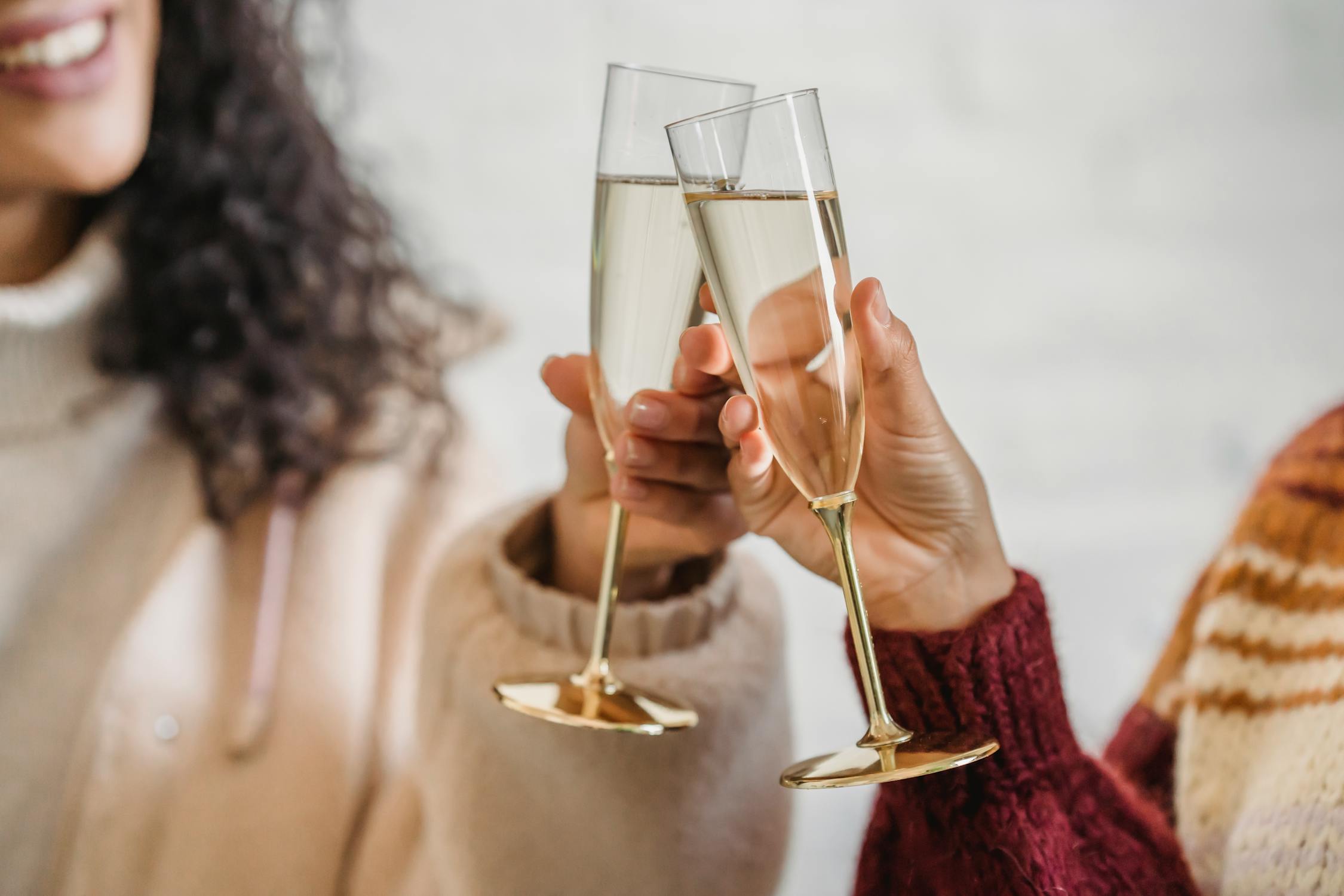 Friends Clinking Glass Of Champagne While Celebrating Occasion · Free