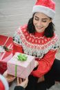 Smiling ethnic woman receiving gift box from person