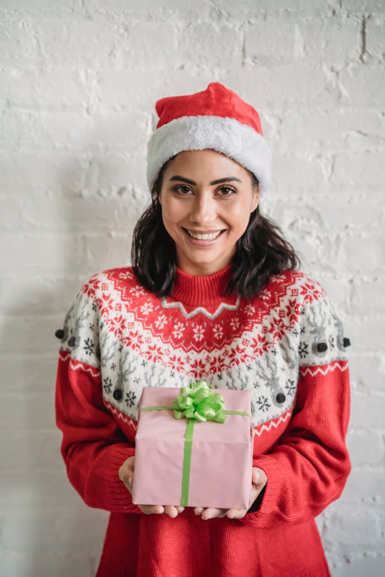 Smiling Ethnic Woman With Wrapped Christmas Present