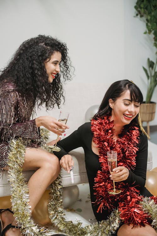 Laughing ladies drinking champagne during festive party