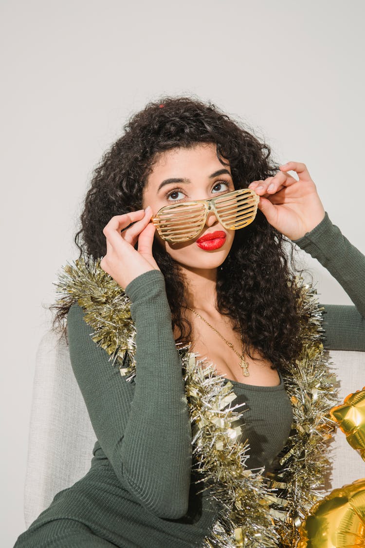 Young Woman In Stylish Glasses And Tinsel At Party