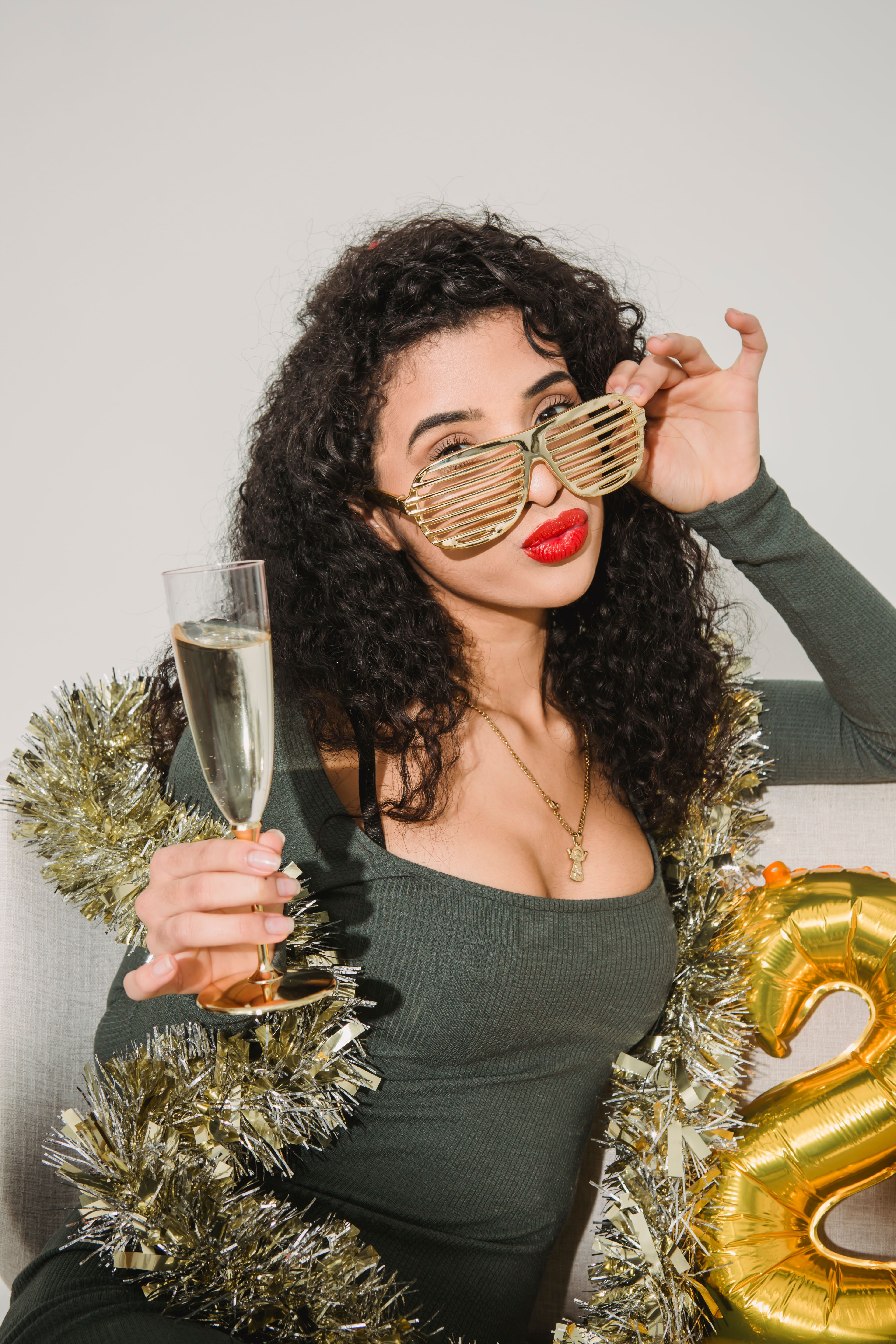 Free Glamour female with red lips in striped glasses with glass of champagne celebrating New Year Stock Photo