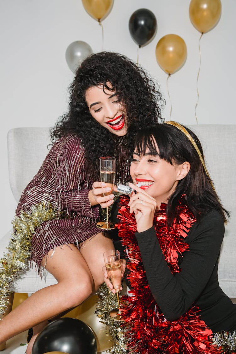 Cheerful Women With Glasses Of Champagne And Party Whistle