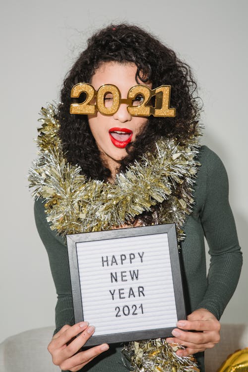 Woman in decorative glasses with frame happy New Year 2021