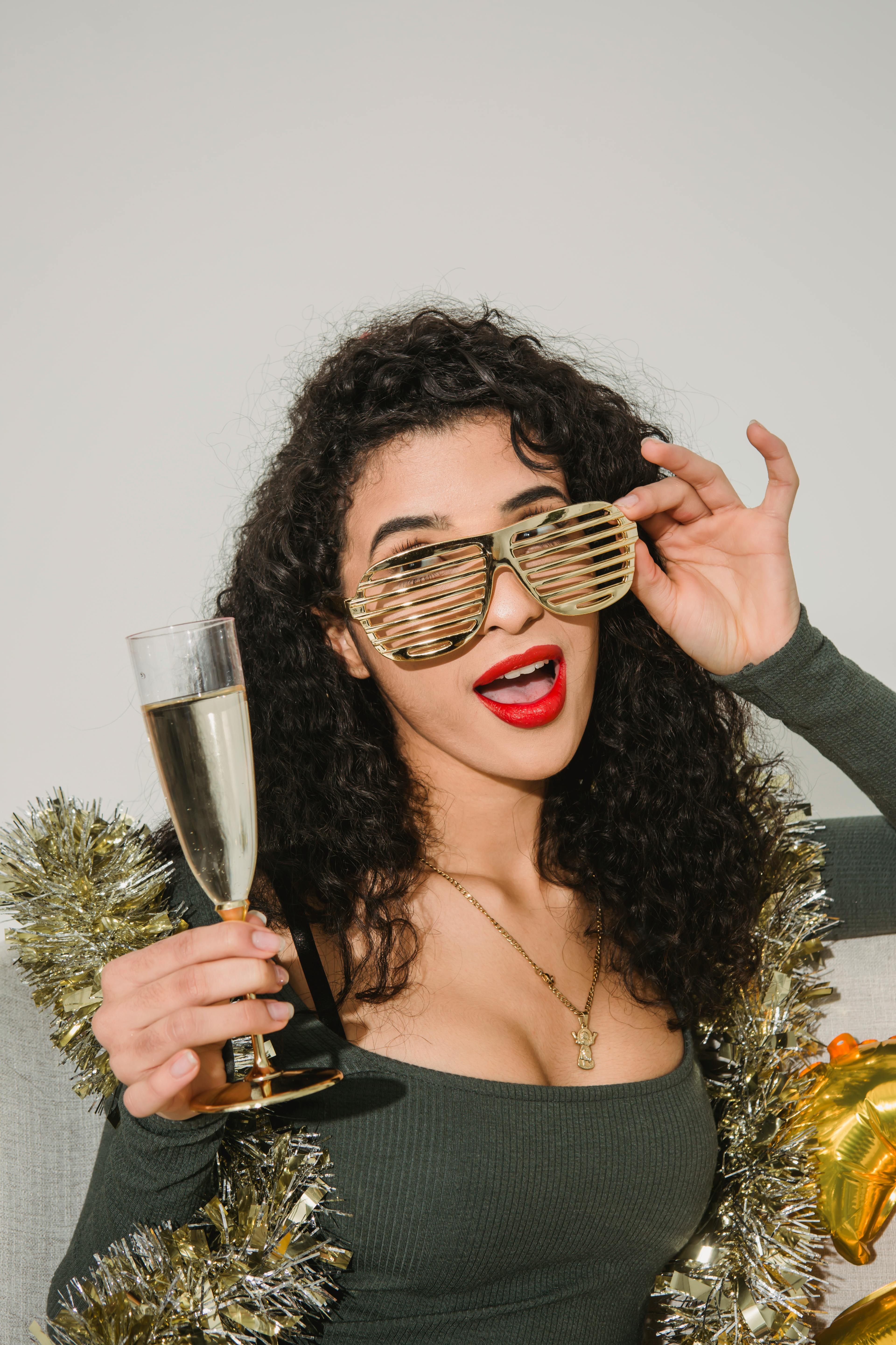 woman in striped glasses with glass of champagne