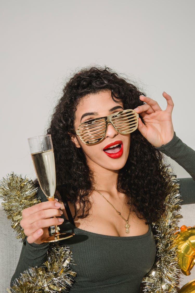 Woman In Striped Glasses With Glass Of Champagne