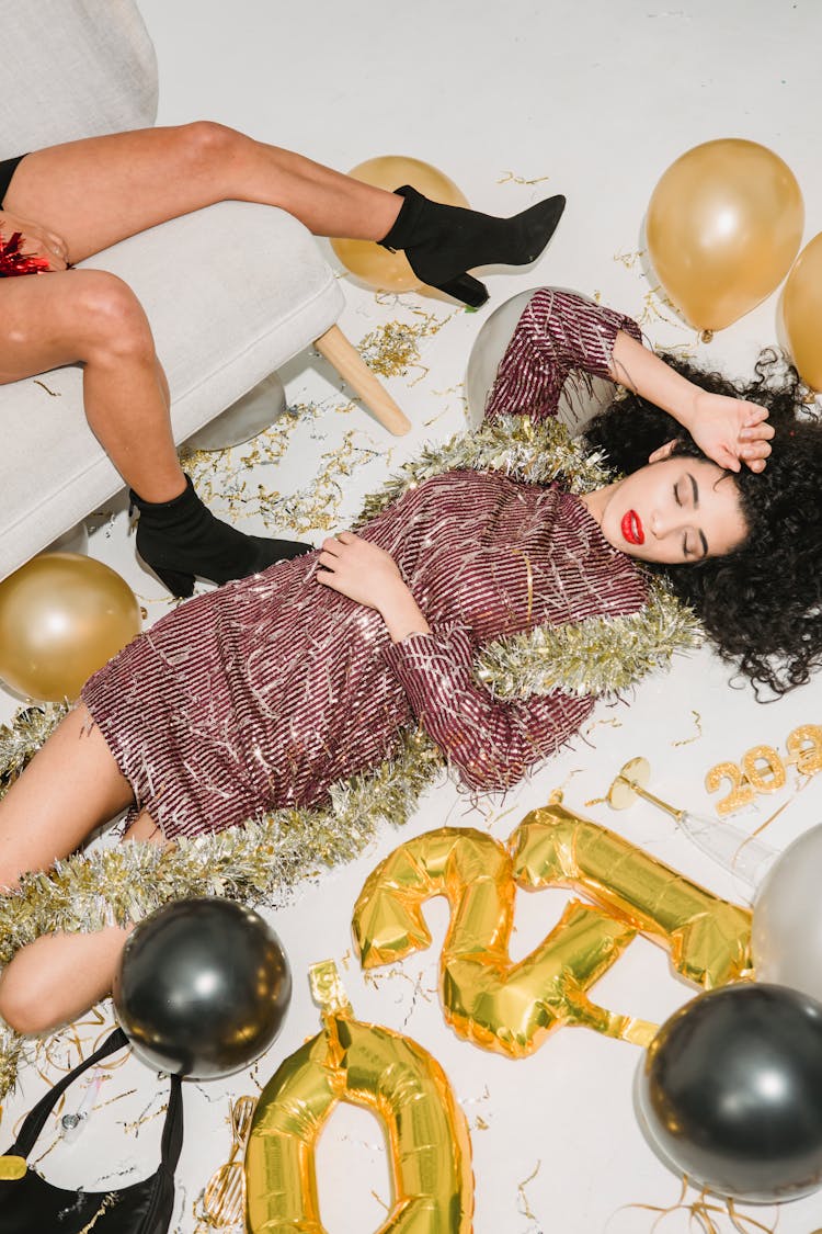 Drunk Women In Sparkling Tinsel Among Balloons