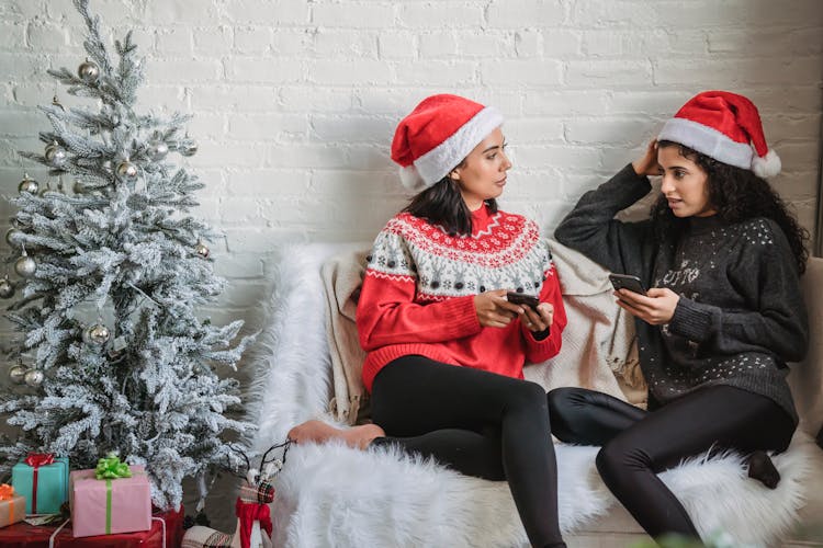 Diverse Women In Santa Hats With Smartphone Talking