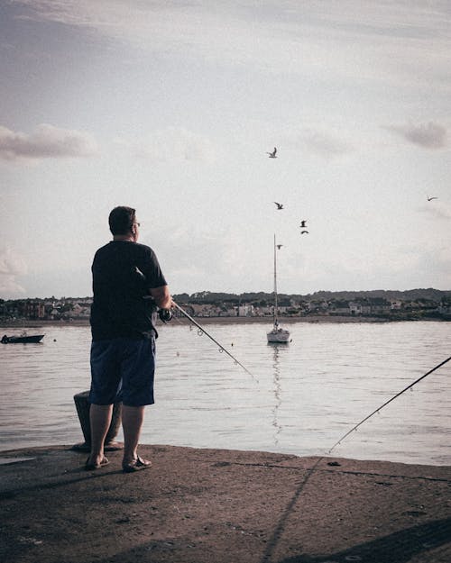Free Back View of a Man Doing Fishing  Stock Photo