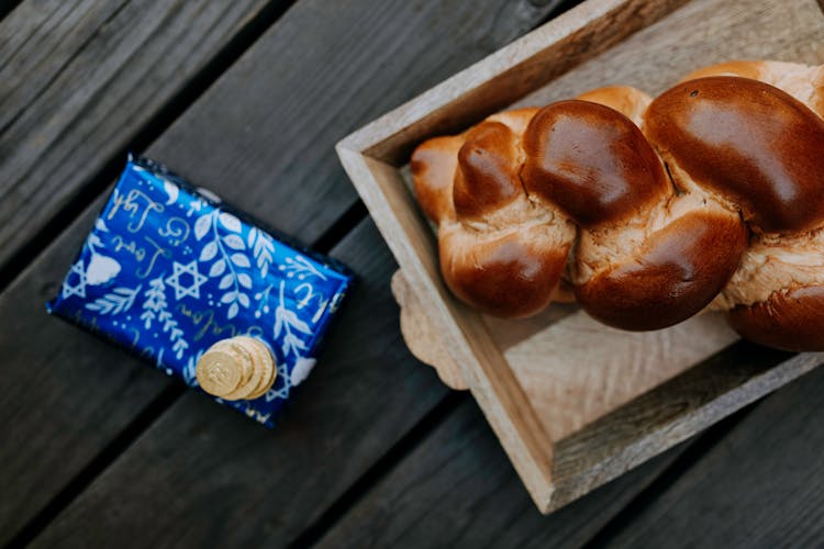 Photo Of Bread On Wooden Tray Beside A Gift Box