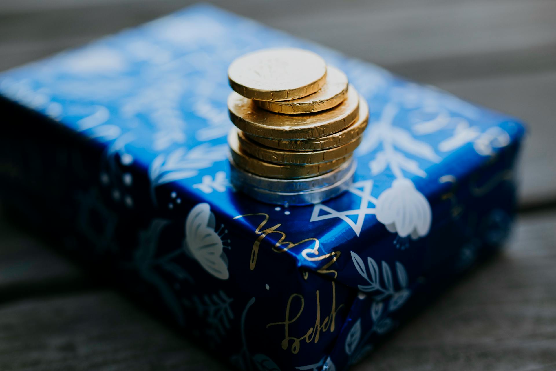 Close-Up Photo Of Gold Coins On Top Of Gift Box