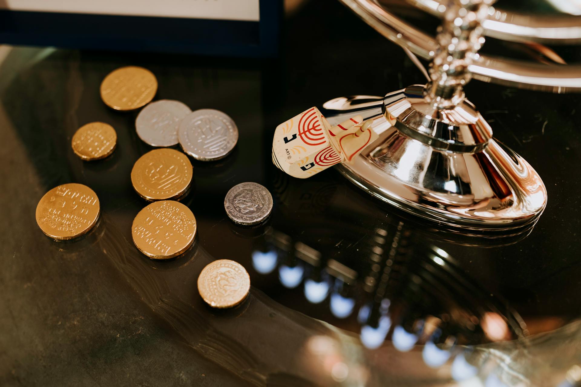 Close-Up Photo Of Gold Round Coins On Top Of Glass Table