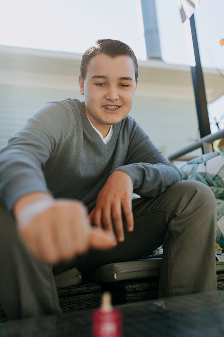 Photo Of Boy Playing Dreidel