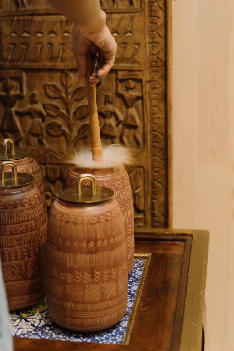 Person Cleaning Clay Jars