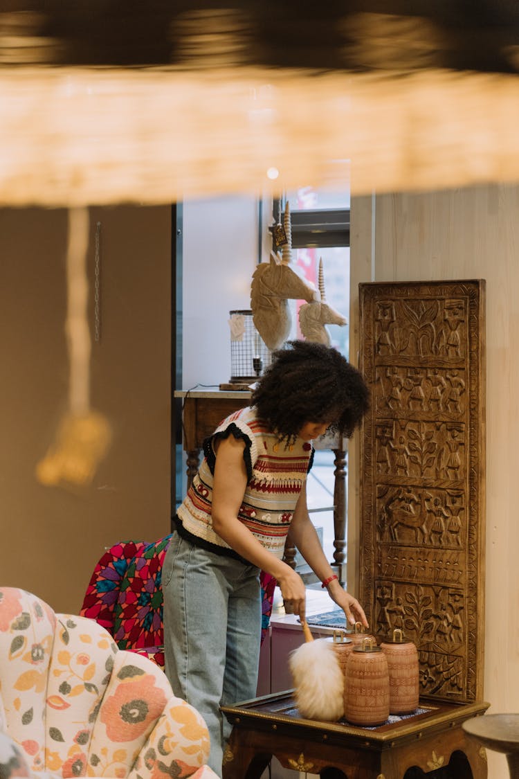 Woman Cleaning Display In Furniture Store