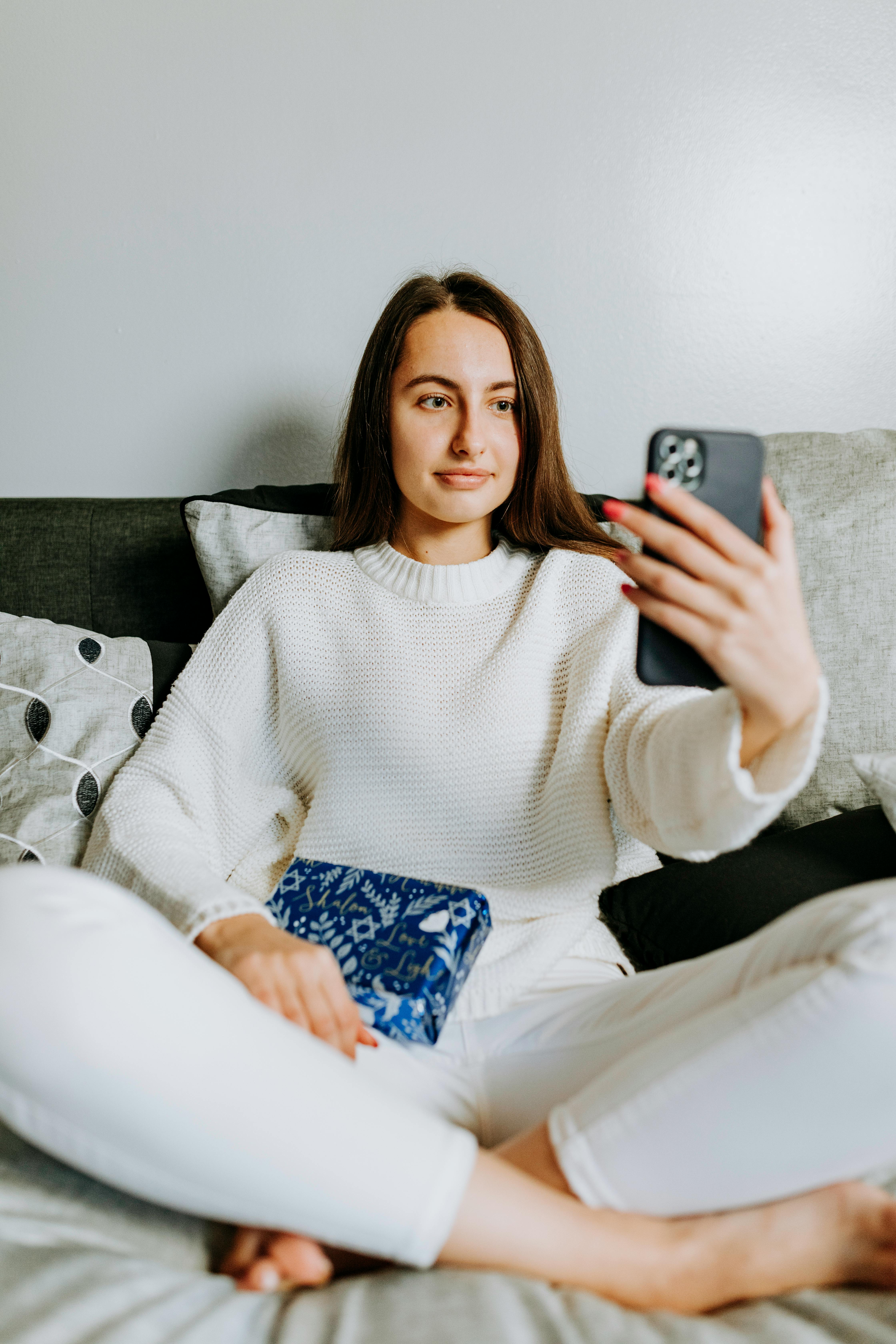 photo of woman holding her smartphone