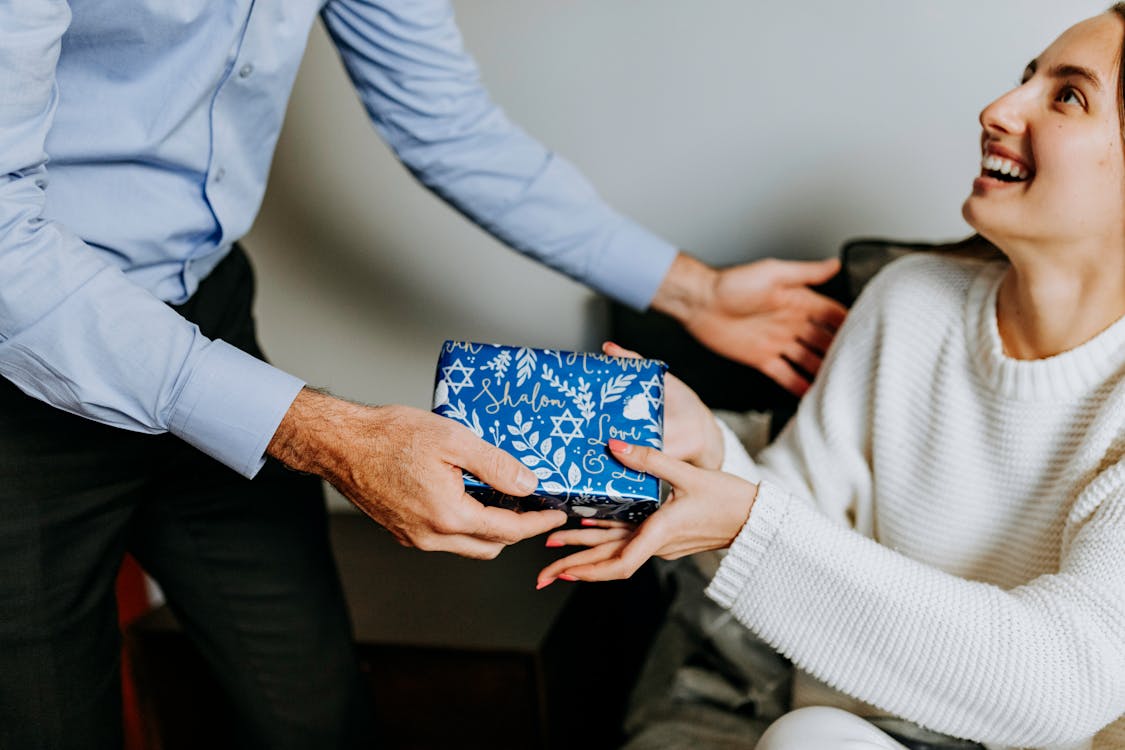 Free Photo Of Person Handing Gift To Woman  Stock Photo