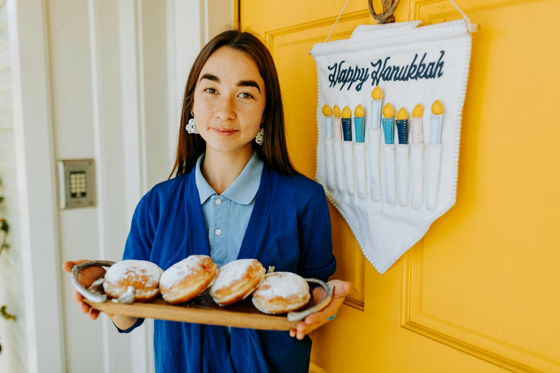 Photo Of Woman Holding A Tray Of Doughnuts