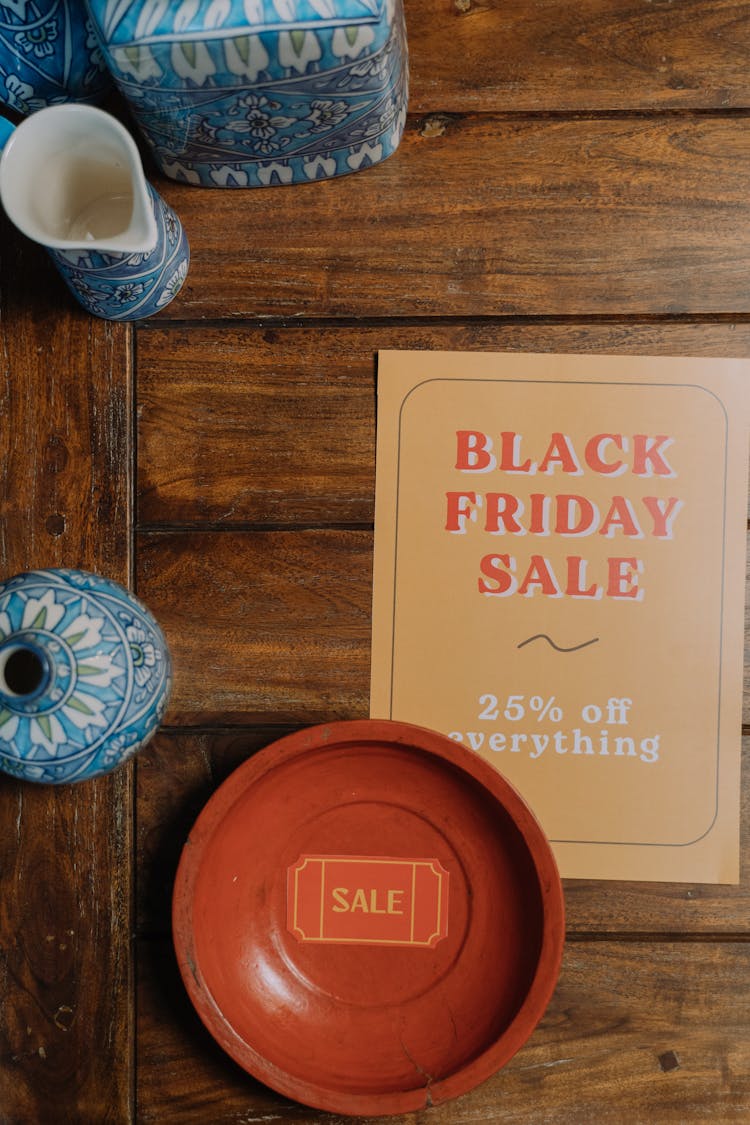 A Sale Tag On Bowl Beside  A Black Friday Sign