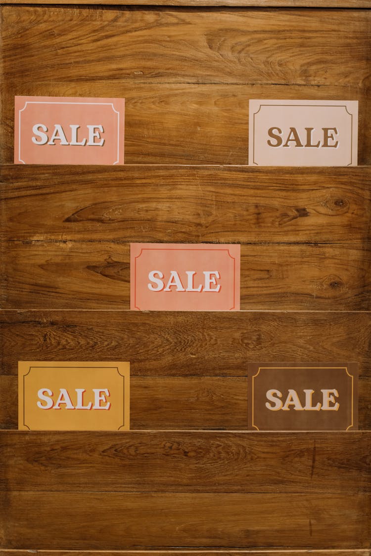 Sale Tags On A Wooden Surface