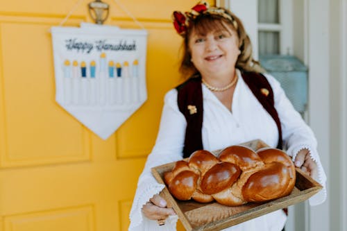 Photo Of Woman Holding A Tray Of Bread