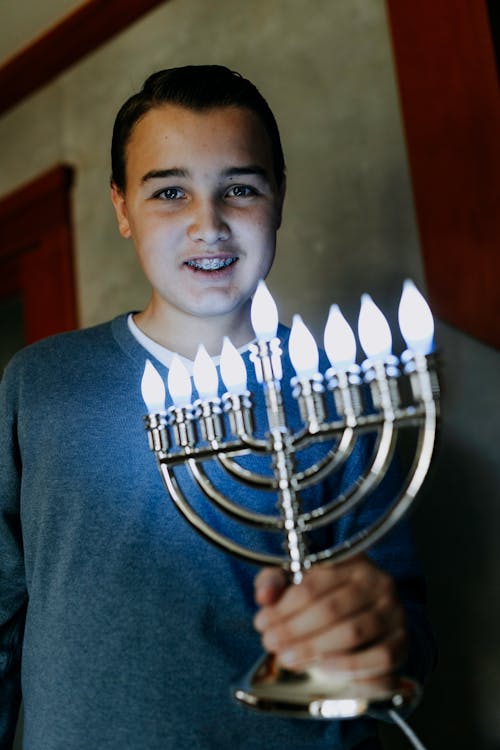 Free Photo Of Boy Holding A Candle Holder Stock Photo