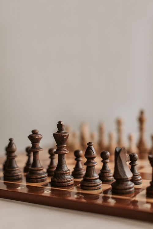Free Close-up of wooden chess pieces on a chessboard, capturing strategic play. Stock Photo