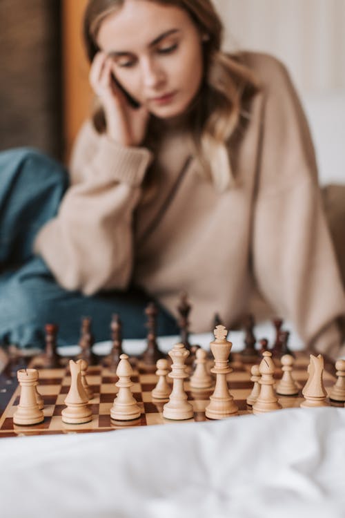 Free A Woman Playing a Game of Chess Stock Photo