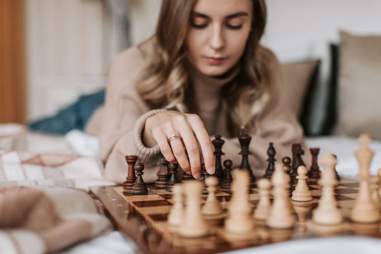 A Woman Playing A Board Game Of Chess