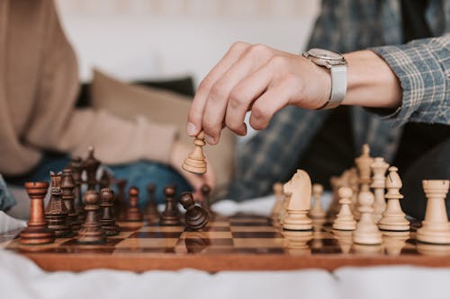 Free A Person Making a Move in a Chess Game Stock Photo
