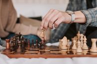 A Person Making a Move in a Chess Game