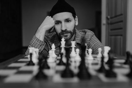 A Bearded Man Playing a Fame of Chess