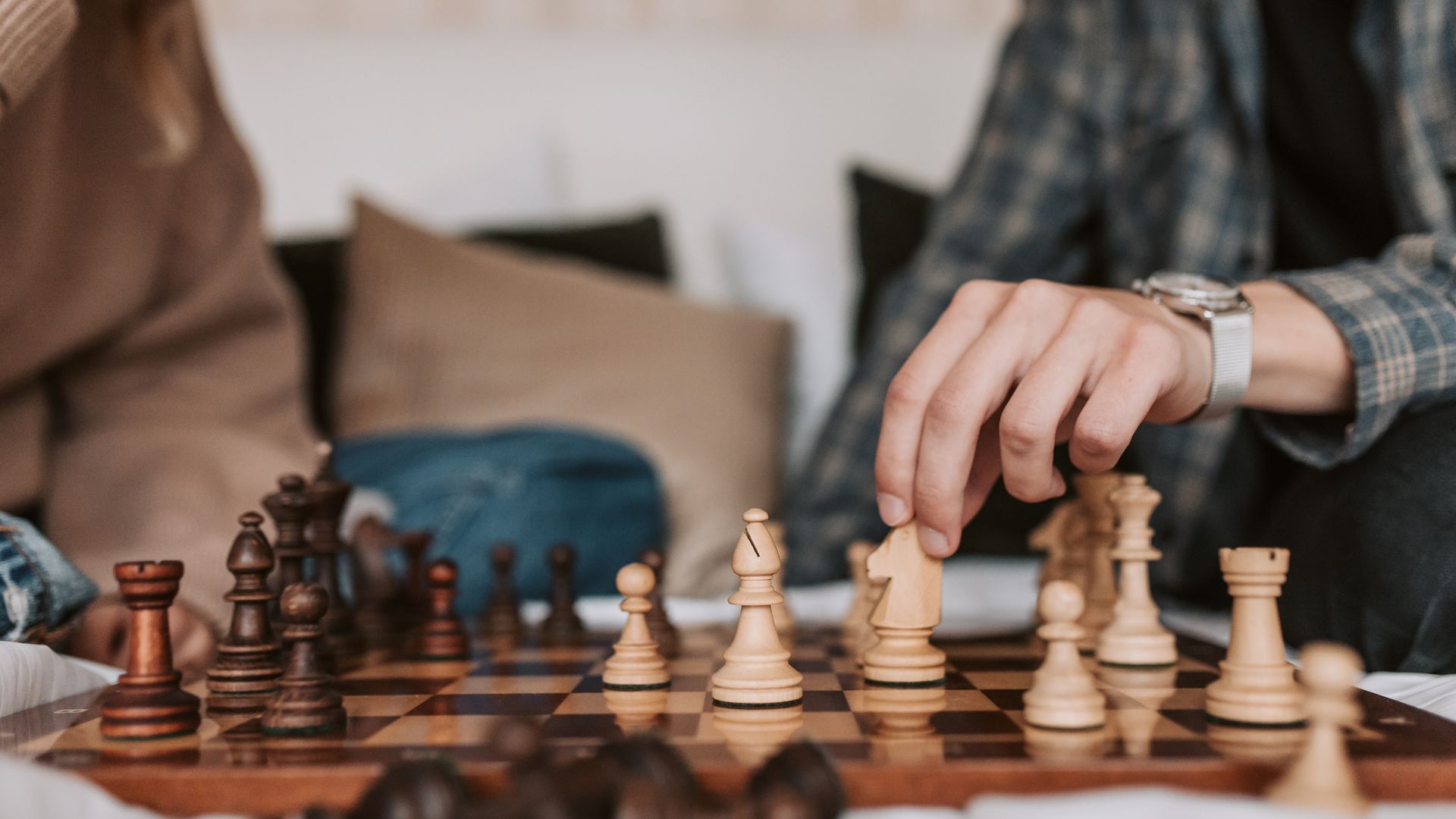 Modafinil for Chess Players: Enhancing Focus and Performance Two people play an intense chess game indoors, focusing intently on strategy — modafinil for chess players