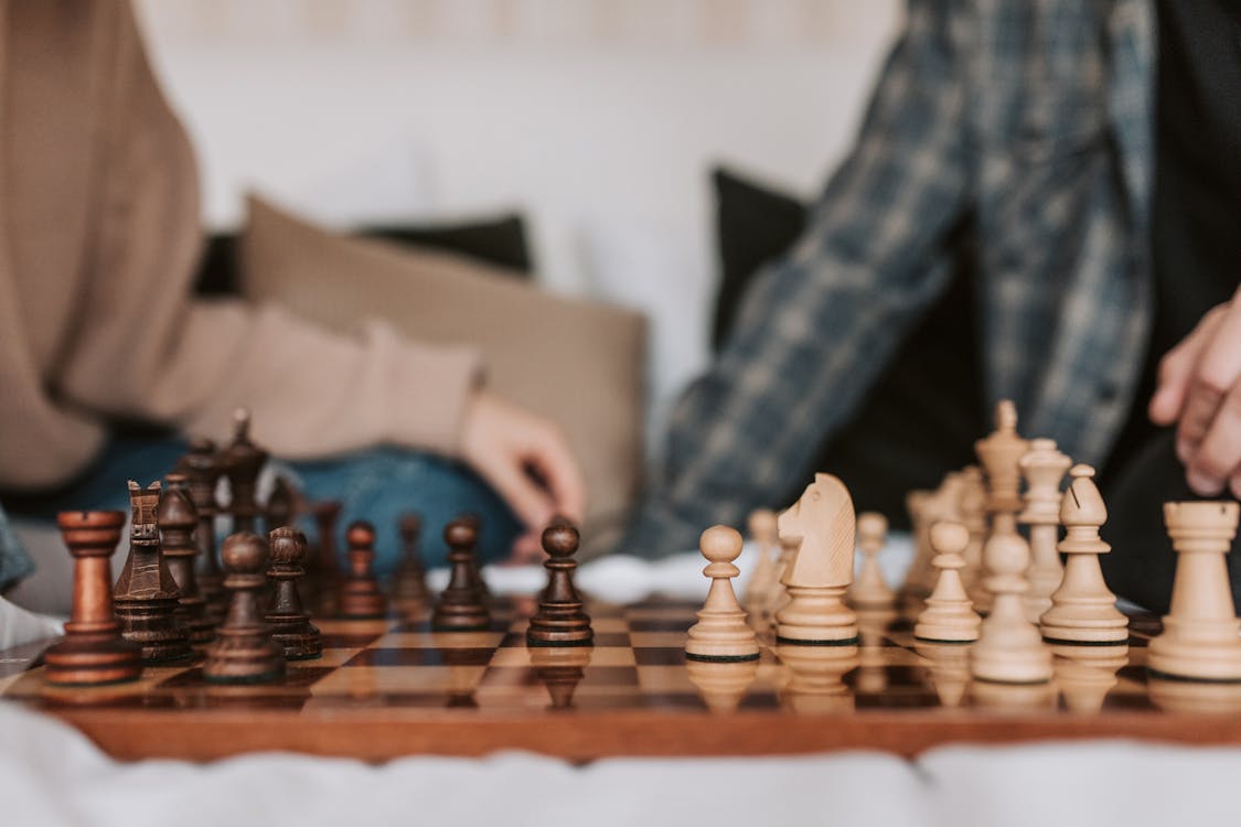 Person Playing Chess Game on Chess Board · Free Stock Photo