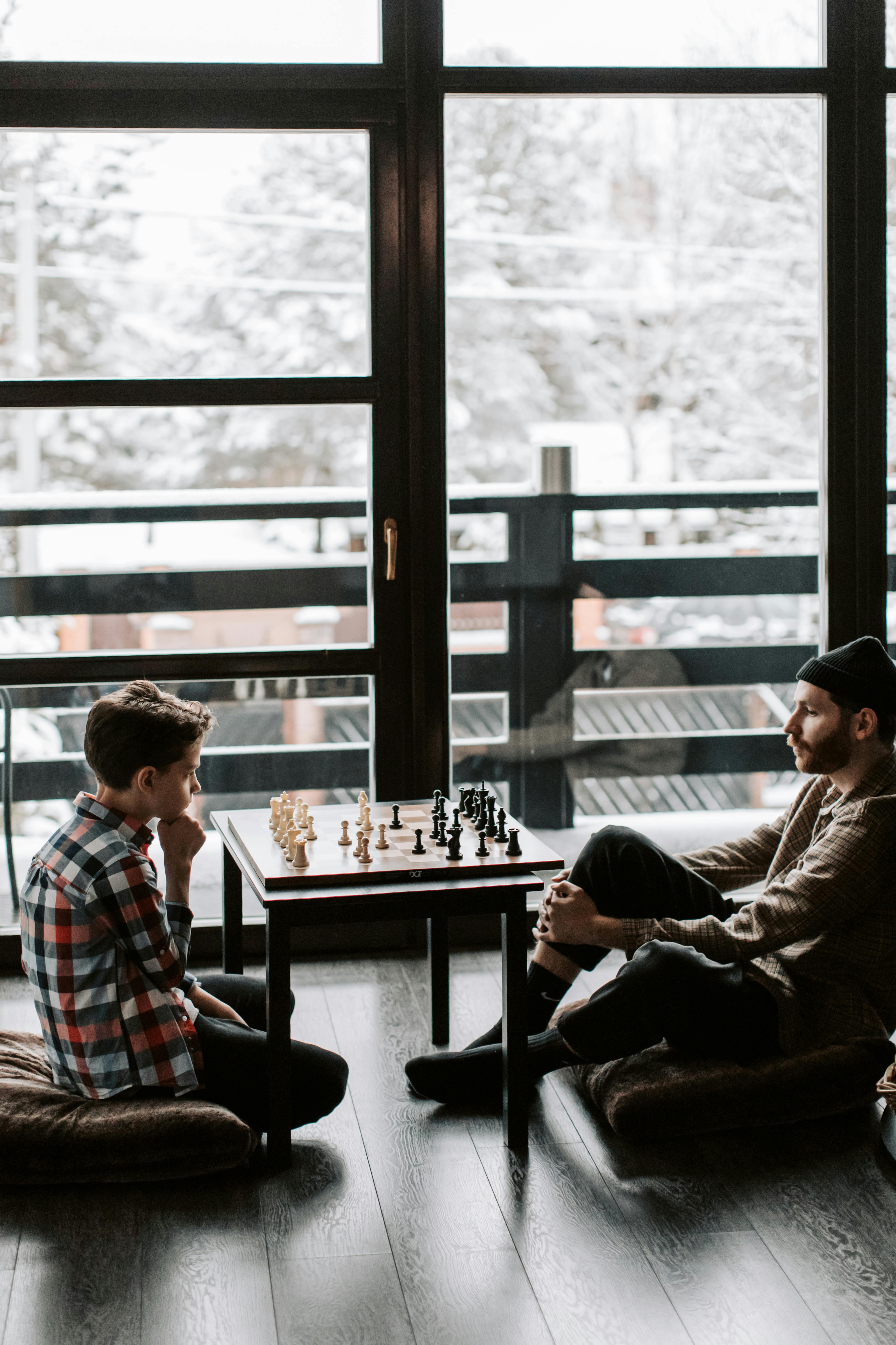 a father and son playing a game of chess