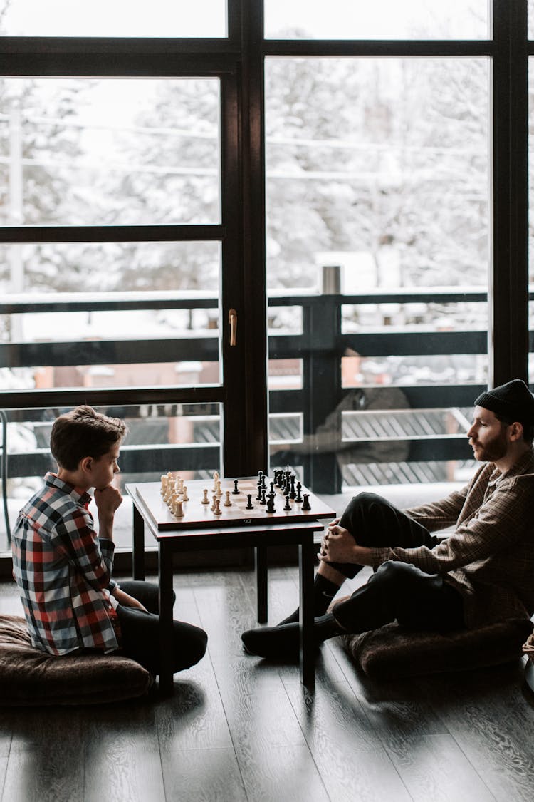 A Father And Son Playing A Game Of Chess