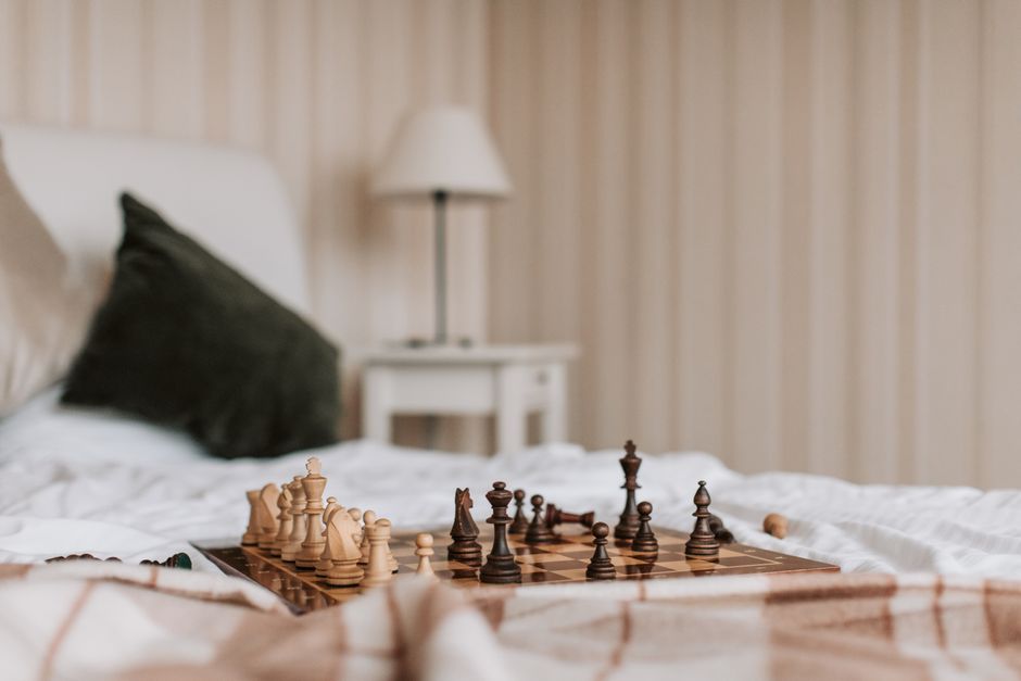 chess pieces on wooden board close up
