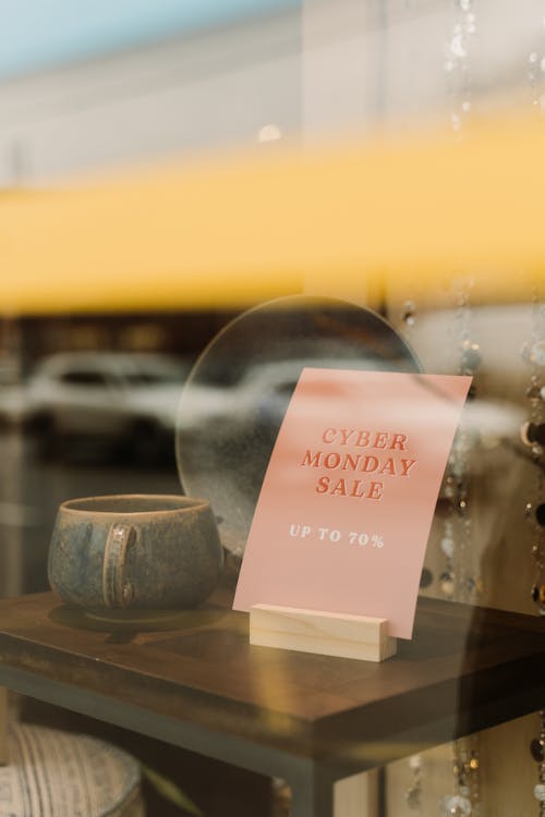 Sale Sign on Brown Wooden Table in Shopping WIndow