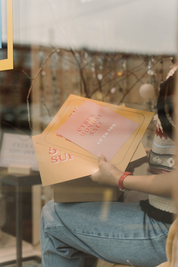 A Person Holding Same Signs Printed On Cardboards