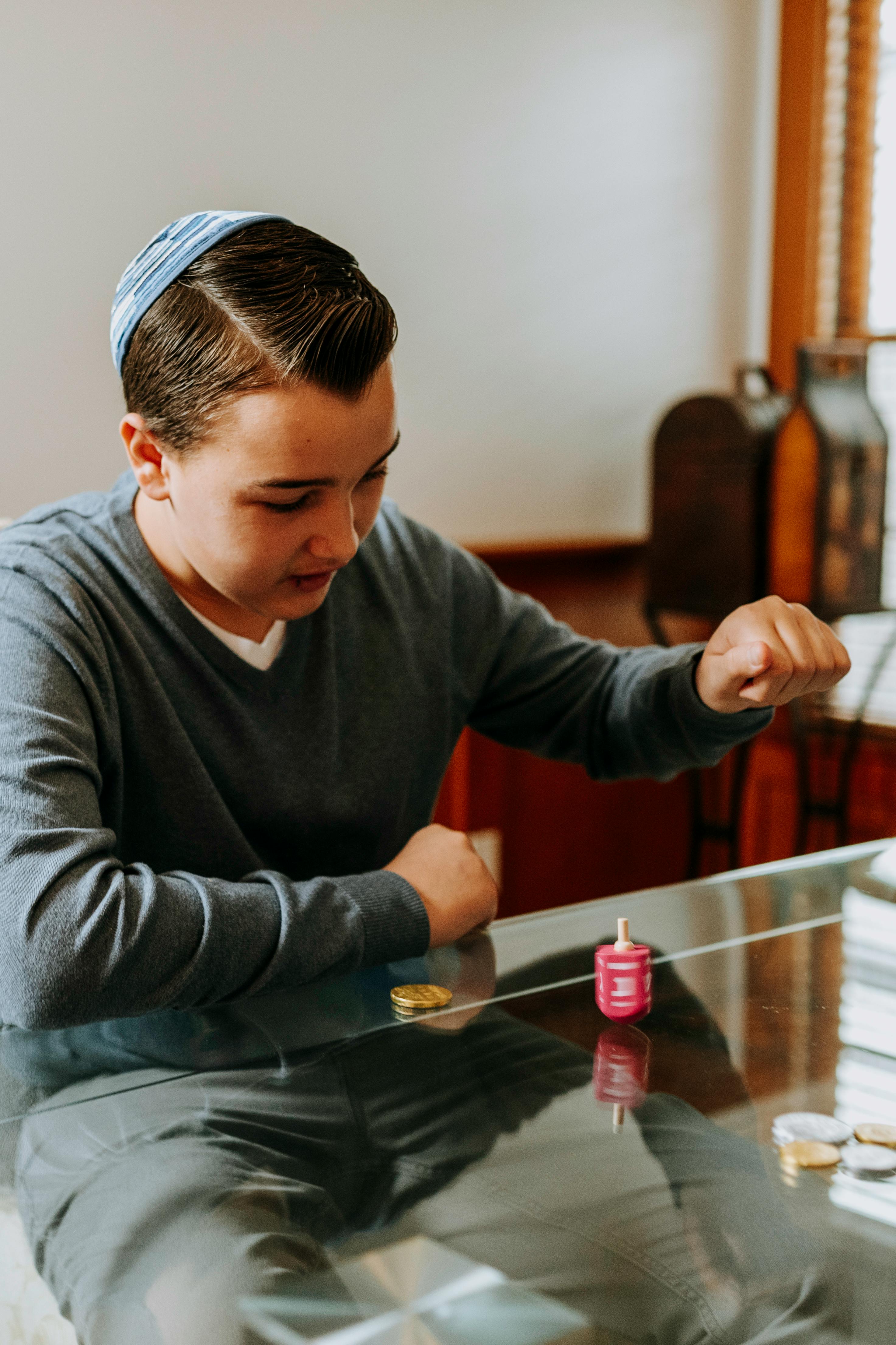 boy having fun playing dreidel