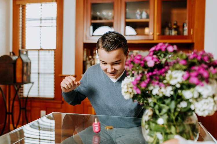 Photo Of Boy Playing Dreidel 