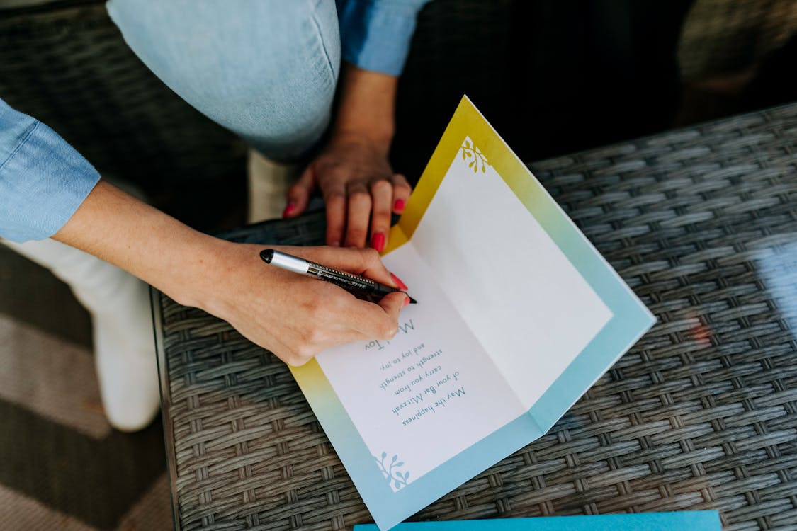 Free Photo Of Person Writing On A Paper Stock Photo