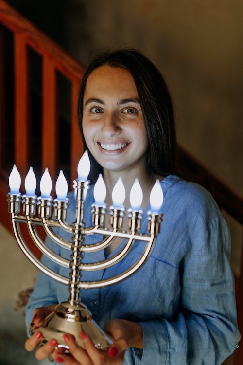 Photo Of Woman Carrying A Candle Holder