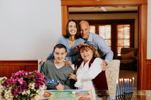 Photo Of Family Gathered Beside Dining Table 