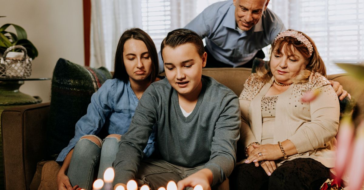 A family gathers to celebrate Hanukkah, lighting a menorah with joy and togetherness.